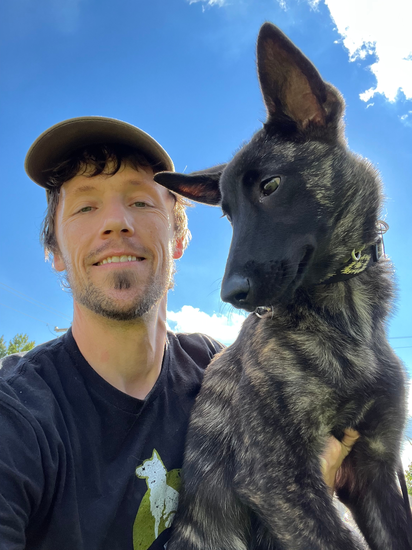 David Gumm with a young Dutch Shepherd outdoors